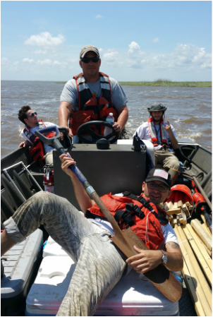 UA and USGS field crews on boat to field site